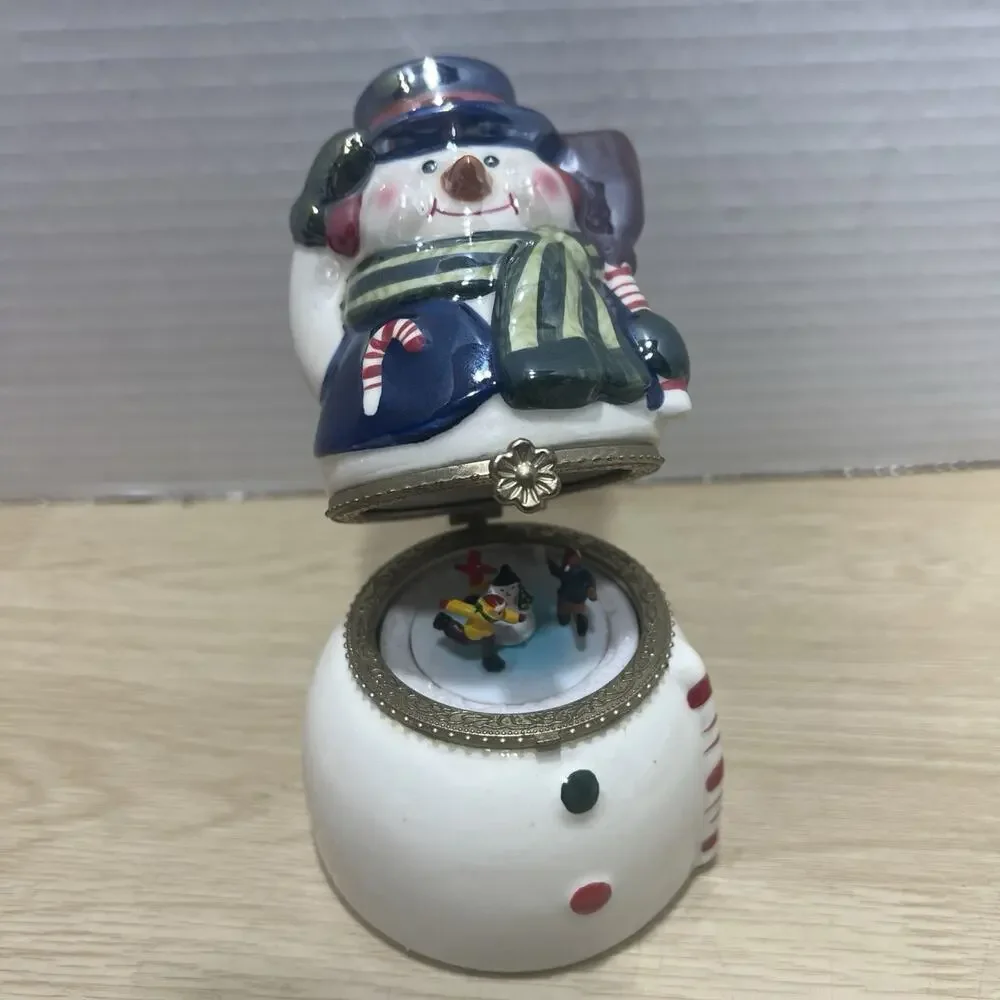 Mr. Christmas Porcelain Snowman is a Hinged Music Box Ornament